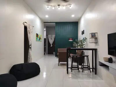a living room with a table and chairs at 32 Impian Homestay, Taiping in Taiping