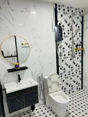 a bathroom with a sink and a toilet and a mirror at The SilverCity Homestay Ipoh in Ipoh
