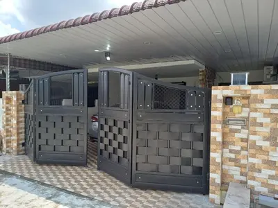 an open gate to a house with a car at The SilverCity Homestay Ipoh in Ipoh