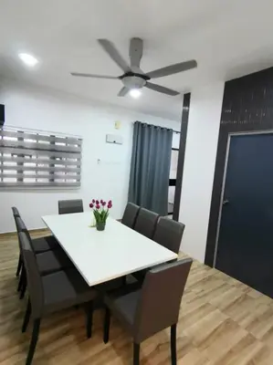 a dining room table with chairs and a ceiling fan at The SilverCity Homestay Ipoh in Ipoh