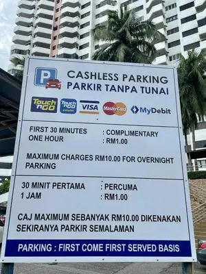 a sign in front of a tall building at Bintara Guesthouse Sri Sayang Batu Ferringhi in Batu Ferringhi