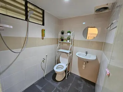 a bathroom with a toilet and a sink at Bintara Guesthouse Sri Sayang Batu Ferringhi in Batu Ferringhi