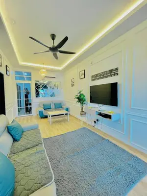 a living room with a couch and a flat screen tv at Homestay DEEDORA in Seri Manjung