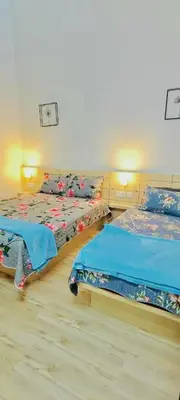 a bedroom with two beds with blue sheets at Homestay DEEDORA in Seri Manjung