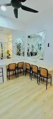 a row of chairs in a room with a ceiling at Homestay DEEDORA in Seri Manjung