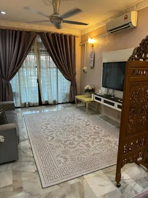 a living room with a flat screen tv and a couch at NuLya Homestay in Kepala Batas