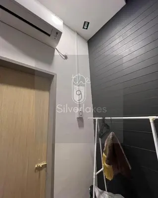a bathroom with a black wall and a towel rack at The9 Silverlakes Homestay in Batu Gajah