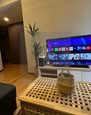 a living room with a table and a large screen tv at The9 Silverlakes Homestay in Batu Gajah