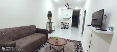 a living room with a couch and a table at D'Iman UTP Seri Iskandar Homestay in Kampung Bota Kiri