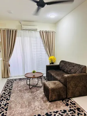 a living room with a couch and a table at D'Iman UTP Seri Iskandar Homestay in Kampung Bota Kiri