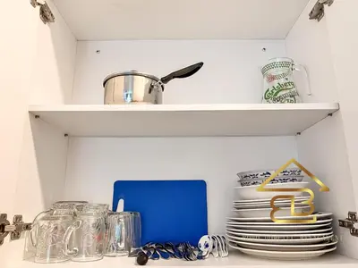 a kitchen shelf with plates and utensils at ANDERSON 2 Room Suite for 6-7 pax in Ipoh