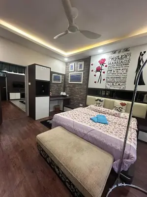 a bedroom with a bed with a blue item on it at H&H Homestay Premium House in Kepala Batas