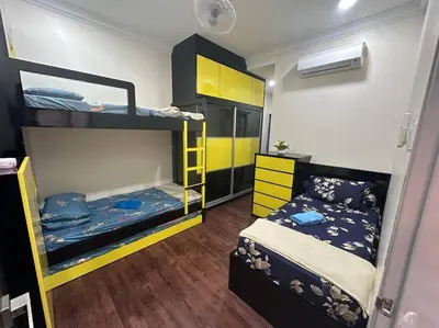 a room with two bunk beds and a bed at H&H Homestay Premium House in Kepala Batas