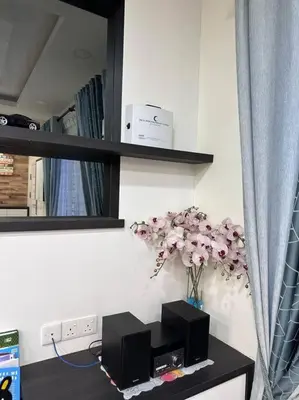 a room with a table with a vase of flowers at H&H Homestay Premium House in Kepala Batas