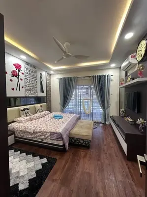 a bedroom with a bed and a tv in it at H&H Homestay Premium House in Kepala Batas