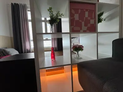 a living room with a table with a bottle on it at 100MBps Unifi Ipoh Anderson Residence Tatami AA2 in Ipoh