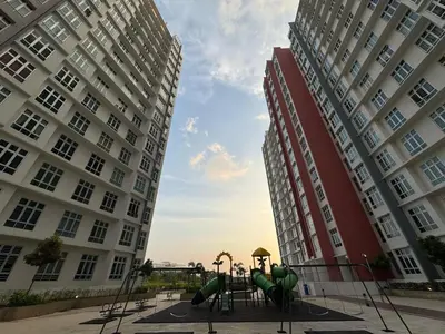 two tall buildings with a playground between two buildings at 100MBps Unifi Ipoh Anderson Residence Tatami AA2 in Ipoh