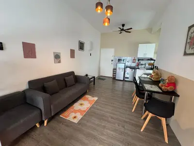 a living room with a couch and a table at 100MBps Unifi Ipoh Anderson Residence Tatami AA2 in Ipoh