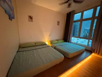 two beds in a room with a window at 100MBps Unifi Ipoh Anderson Residence Tatami AA2 in Ipoh
