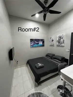 a bedroom with a bed and a ceiling fan at Matsurika Guest House - Kulim in Kulim