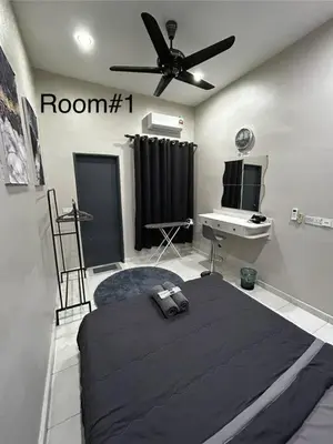 a bedroom with a bed and a ceiling fan at Matsurika Guest House - Kulim in Kulim