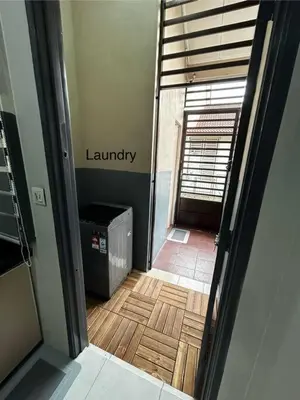 an empty room with a hallway with a wooden floor at Matsurika Guest House - Kulim in Kulim