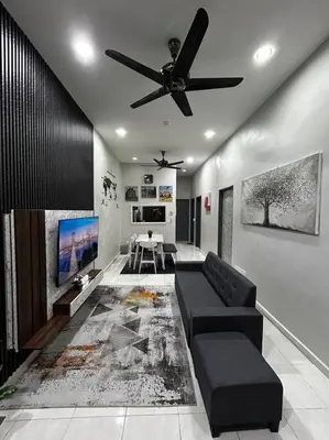 a living room with a couch and a ceiling fan at Matsurika Guest House - Kulim in Kulim