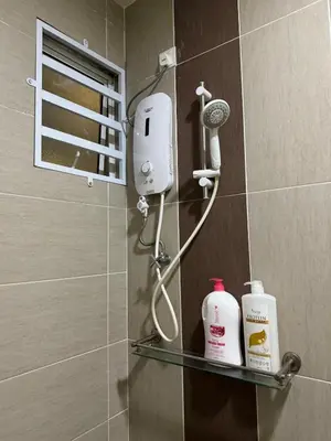 a bathroom with a shower with a blow dryer on a shelf at Tea Valley & Farm View at Cool Summer Cameron in Cameron Highlands