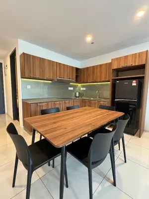 a large kitchen with a wooden table and chairs at Sunway Onsen Suite in Tambun