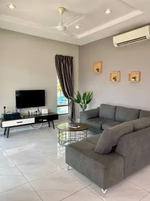 a living room with a couch and a tv at LYL Journey House at Ipoh Town Centre 17PAX 6BR in Ipoh