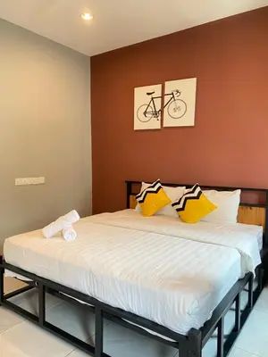 a bed in a room with a bike on the wall at LYL Journey House at Ipoh Town Centre 17PAX 6BR in Ipoh