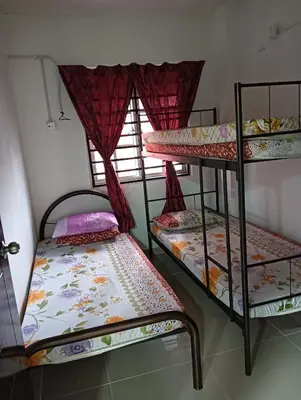 two bunk beds in a room with a window at Yaakub homestay pangsapuri sutera jaya in Perai