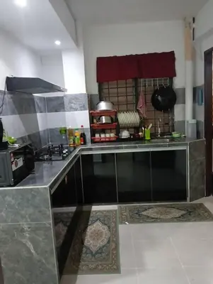 a kitchen with a counter top in a room at Yaakub homestay pangsapuri sutera jaya in Perai