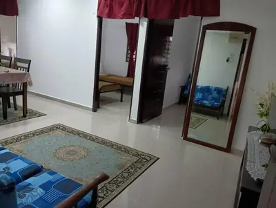 a living room with mirrors and a rug on the floor at Yaakub homestay pangsapuri sutera jaya in Perai