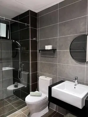 a bathroom with a toilet and a sink and a shower at ONSTAY Sunway Onsen Suites in Ipoh