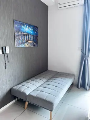 a bench in a room with a painting on the wall at ONSTAY Sunway Onsen Suites in Ipoh