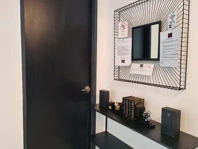 a room with a black door and a mirror at Luxurious Modern Suite at Urban Suites Georgetown by SuperStay in Jelutong
