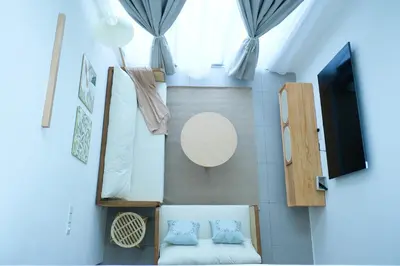 a small room with two beds and a tv at Bunny's Warm Penthouse by Comfy Sofy in Brinchang