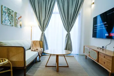 a living room with a couch and a table at Bunny's Warm Penthouse by Comfy Sofy in Brinchang