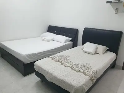 two beds sitting next to each other in a room at Nuha Kulim Hitech Homestay Islamic in Kulim
