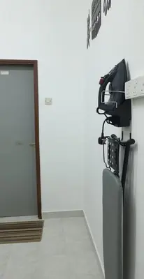 a fax machine sitting on top of a refrigerator at Nuha Kulim Hitech Homestay Islamic in Kulim
