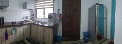 a kitchen with a sink and a refrigerator at Nuha Kulim Hitech Homestay Islamic in Kulim