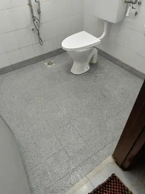 a bathroom with a white toilet in a stall at Nuha Kulim Hitech Homestay Islamic in Kulim