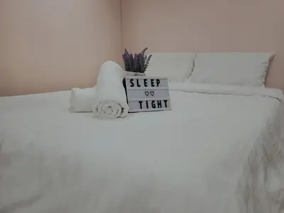 a white bed with a sign on top of it at Cameron Brinchang 5 Min to Centrum 12pax Duplex Shophouse by City Home Empire in Brinchang