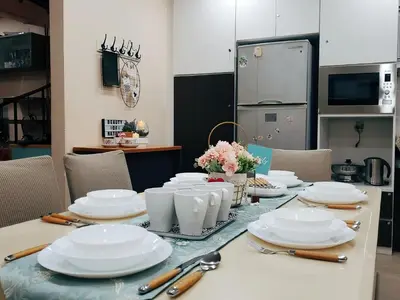 a table with white plates and utensils on it at Cameron Brinchang 5 Min to Centrum 12pax Duplex Shophouse by City Home Empire in Brinchang