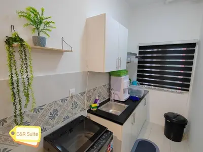 a small kitchen with a sink and a microwave at Anderson, Ipoh at E&R Suite in Kampong Simee