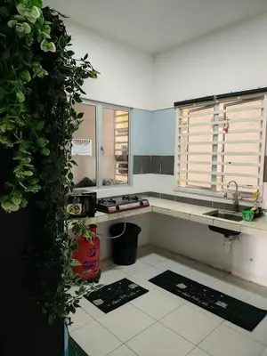 a kitchen with a sink and a counter with plants at DLAZ HOMESTAY in Tanah Rata