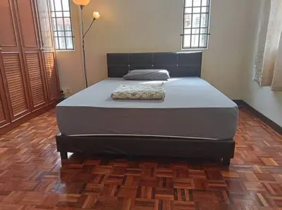 a large bed in a room with a wooden floor at Taman Sunway Tunas in Bayan Lepas