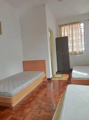 a bedroom with two beds and a wooden floor at Taman Sunway Tunas in Bayan Lepas