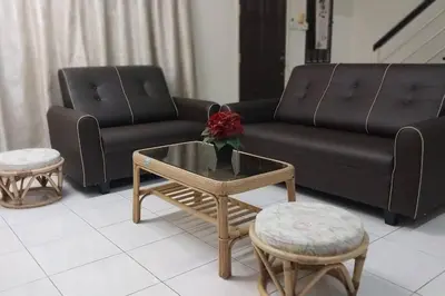 a living room with a couch and a coffee table at Taman Sunway Tunas in Bayan Lepas